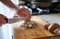 Mens hands cut Fresh mushrooms in kitchen