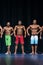 Mens Physique Posing During A Bodybuilding Competition