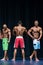 Mens Physique Posing During A Bodybuilding Competition