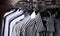 Mens shirts in different colors on hangers