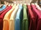 Mens shirts in different colors on hangers in a retail clothes s