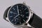 Mens silver watch with a black dial, blue clockwise, chronograph, stopwatch, with a black leather strap with blue line.