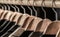 Mens suits in different colors hanging on hanger in a retail clothes store, close-up. Mens shirts, suit hanging on rack