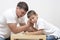 Mens Things. Father with His Little Son Having Arm-Wrestling Session Indoors