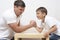 Mens Things. Father with His Little Son Having Arm-Wrestling Session Indoors. Showing Physical and Emotional Tension