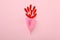 Menstrual cup and gerbera petals on background, space for text