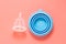 Menstrual cup isolated on pink background. Feminine health care product, reusable feminine hygiene product