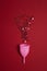 Menstrual cup with stars glitter on red background