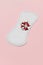 Menstrual pad with red heart glitter on pastel colored background. Minimalist still life