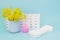 Menstrual pads and menstrual cup for blood period. Menstruation period pain protection. Feminine hygiene products and yellow