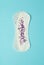 Menstruation concept. Woman menstruation cycle  women`s period and critical days. Sanitary pad on blue background