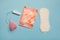 Menstruation products, intimate hygiene and protection, sanitary pads, tampon and menstruation cup on blue