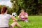 Mental disabled woman is throwing a ball to a woman to train her motor function