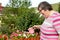 Mental disabled woman is watering some flowers