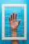 Mental health concept. Women`s hands try to break the fetters on blue background