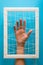 Mental health concept. Women`s hands try to break the fetters on blue background