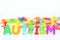 Mental health disorder, autism word with colored toys figurine on white background