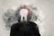 A mental health, wellness concept. A mans head covered in clouds. With a double exposure of a mans silhouette and keyhole over