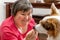 Mentally disabled woman is feeding a dog