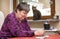 Mentally disabled woman playing cards, therapeutic at everyday l