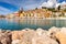 Menton. Antique multi-colored facades of medieval houses on the shore of the bay.