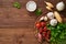 Menu, recipe, mock up, banner. Food seasoning background. Spices, Herbs and round wooden cutting board on brown dark wooden