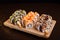 Menu of Ukrainian seafood restaurant. Japanese sushi rolls. Sushi set maki with shrimp,  tuna, eel and avocado. Dish on a wooden