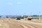 Menzelinsk, Russia - August 7, 2014: Tractor straw stacks during