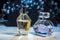 Menâ€™s and womenâ€™s perfumes in a glass bottle on a wooden table against the background of spring flowers