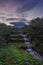 Merapi volcano with lenticular cloud on the peak of mountain with terraced waterfall