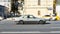 Mercedes-Benz E-Class Coupe C124 on the street in motion. Fast speed drive on city road. Side view of moving gray car on the urban