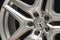 Mercedes Benz logo aluminum cast wheel, close-up, original silver wheel new in black background closeup