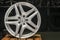 Mercedes Benz logo aluminum cast wheel, close-up, original silver wheel new in black background copyspace, copy space