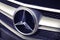 Mercedes Benz logo on a car. Mercedes-Benz is one of the most well-known and established automotive brands in the world.