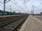 Merchandise train station. View of train tracks with rails and freight wagons with power lines