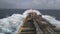 A merchant ship underway at sea in rough weather