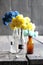 Merci tag and nice flowers in the bottles on wooden table