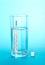 Mercury thermometer, glass with water and tablets