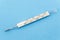 Mercury thermometer isolated on blue