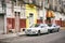 Merida / Yucatan, Mexico - June 1, 2015: The cars parking infront of the old buiding in contrast with bright yellow color wall in