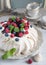 Meringue cake with raspberries and blueberry jam. Provence vintage style, ancient cruisers, cups, spoons