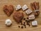 Meringue, cinnamon hearts cookies and sticks and turkish delight wood texture