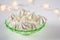 Meringue cookies on a green glass retro plate