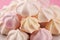 Meringue. Crispy white and pink twisted meringue. Concept love o