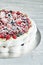 Meringue pavlova wreath cakes with whipped cream and fresh berries