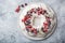 Meringue pavlova wreath cakes with whipped cream and frozen berries