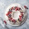 Meringue pavlova wreath cakes with whipped cream and frozen berries