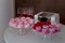 Meringues and macarons on glass coasters, butterfly cookies in glasses, glasses of pink champagne, a box of