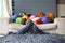 Merino wool balls in multicolour lying on white sofa with merino