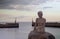 Mermaid statue on the coast of Asaa Docks, Denmark under a cloudy sky